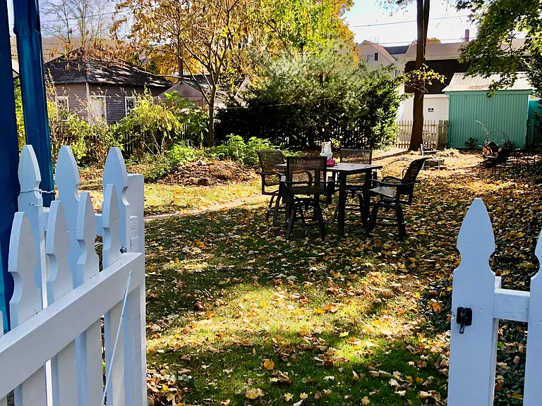 Fenced backyard shared if different tenants in house and apartment. Has veggie garden and fire pit.