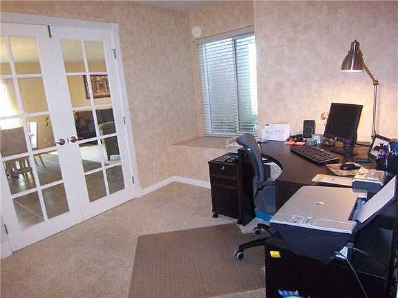 Office has french doors and bay windows.