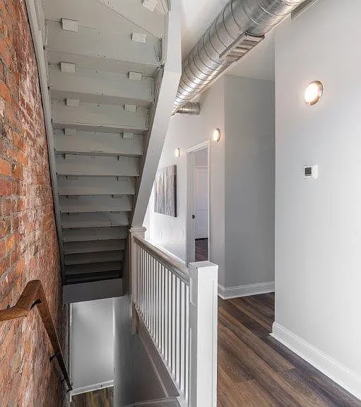 The entrance has a small landing and a flight of stairs.