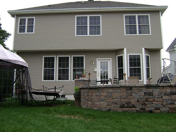 Rear view of home with Raised paver patio
