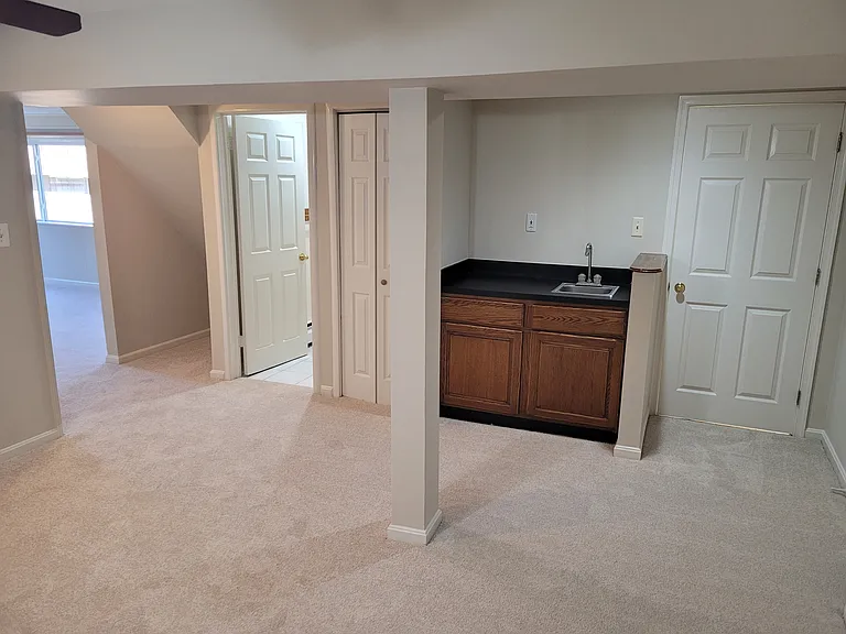 Basement with two additional carpeted rooms, full bath and wet bar