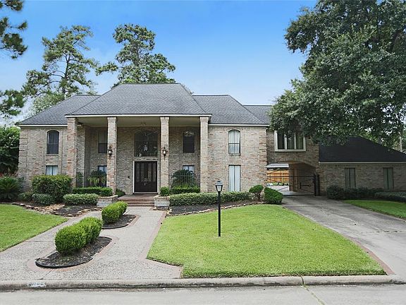 This lovely home has an automatic driveway gate, leading through a porte-cochere to a 3 car back load garage, with extra parking spot behind.