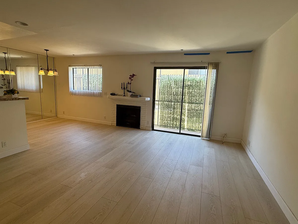 Living room/Dining area with faux fireplace and sliding door to emergency walkway(not a balcony) - 4322 Matilija Ave #7