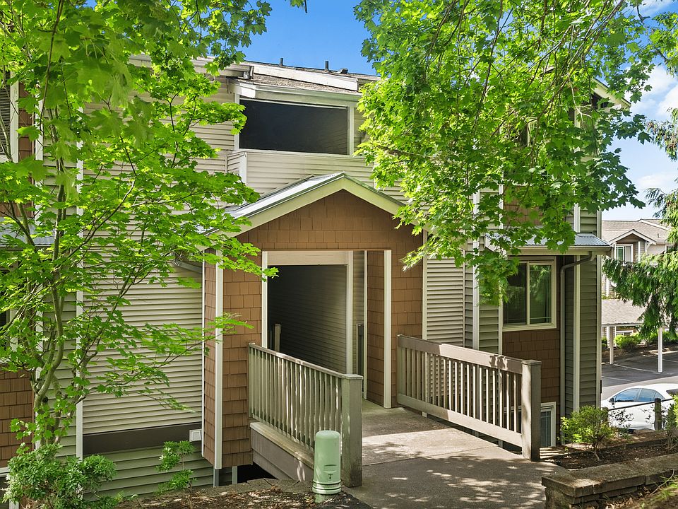 Charming community entrance surrounded by mature greenery.