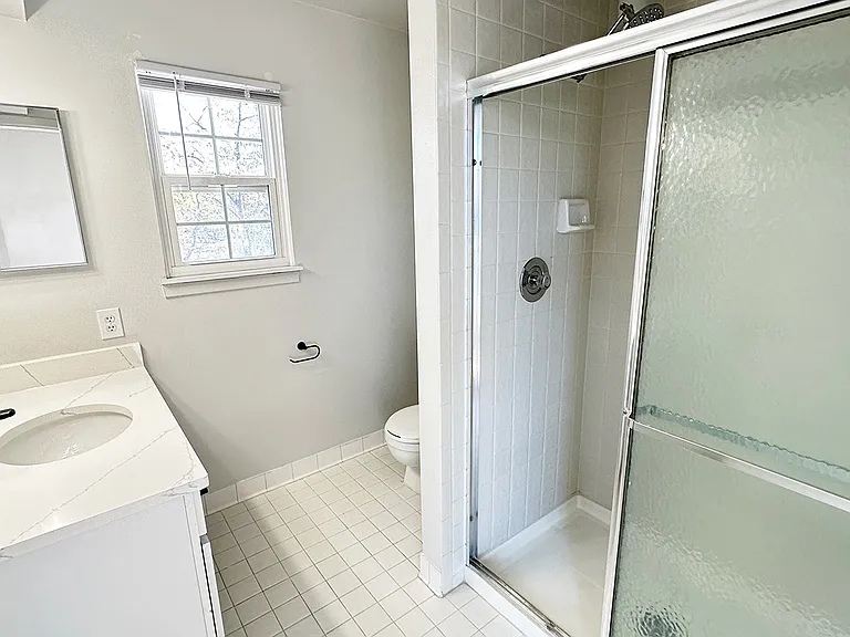 Upscale upgraded unusually spacious townhomes with luxe baths including a light-loving window, ceramic tile, extra large shower, marble countertops and sleek white cabinetry.