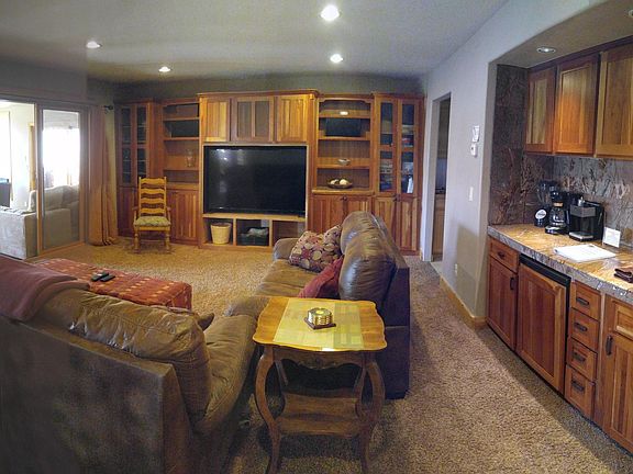 Spacious family room with full wet bar/ mini fridge and huge TV.
