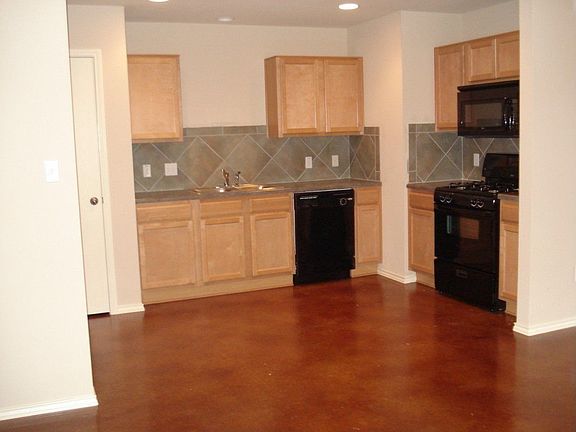 Open Kitchen with Decorative Tile Backsplash and Appliance Package