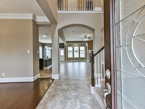 Natural light fills this dynamic home. Soaring ceilings greet you as you enter the foyer.
