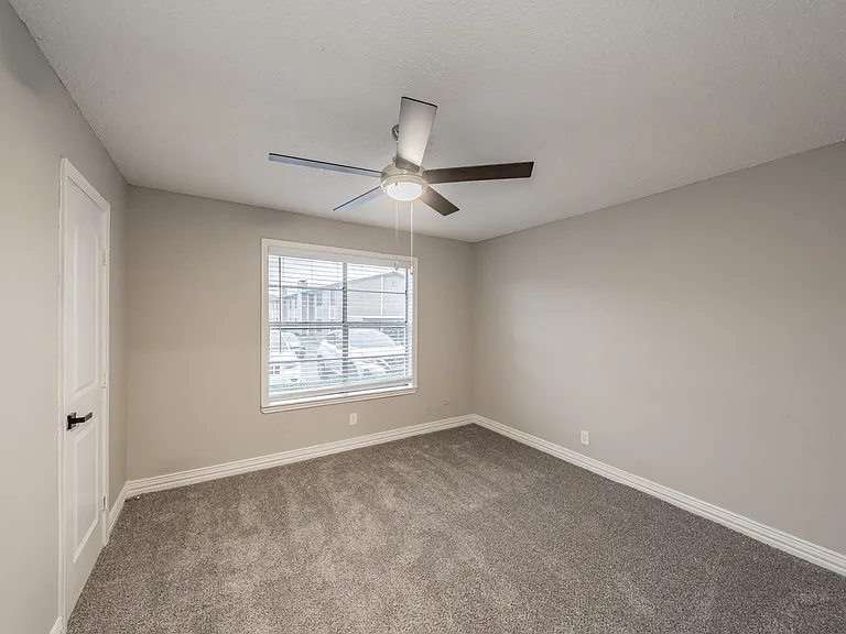 Comfortable bedroom with natural light and ample closet space.