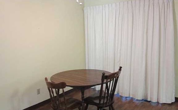 Dining area with doors leading to sunroom/den