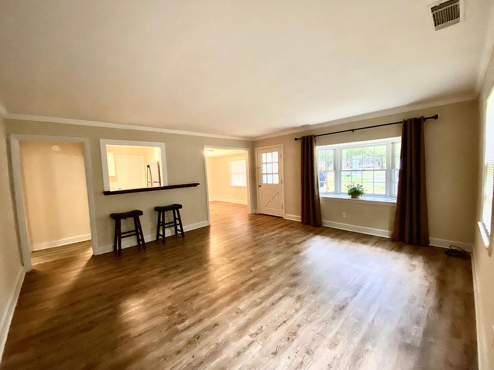 Large Living room with bar seating at kitchen.
