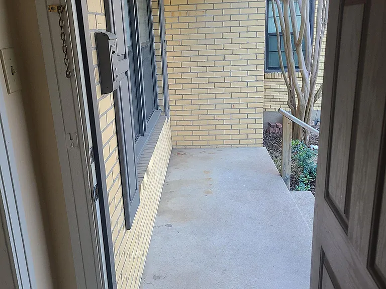 Front door open looking onto front porch