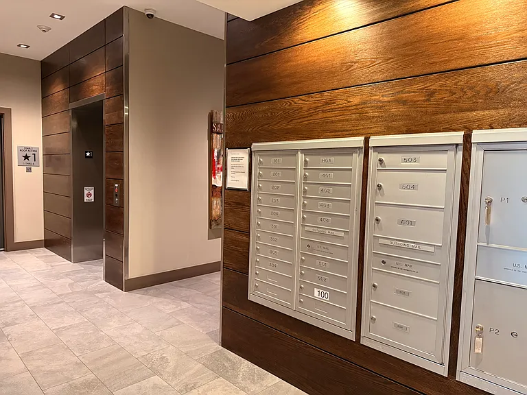 Step into a clean, modern building featuring a pristine lobby, elevators for easy access, and convenient first-floor amenities like a mailroom and trash/recycling center.