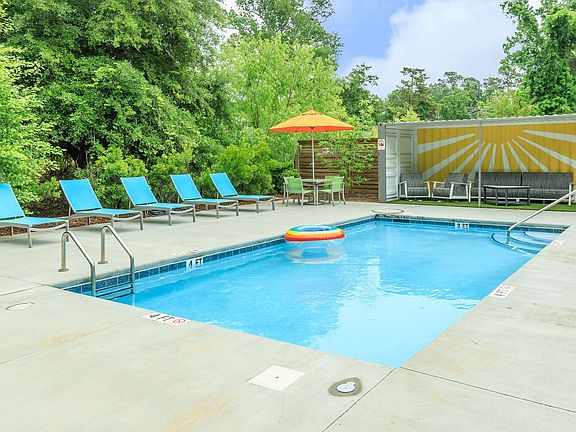 SOAK UP THE SUN BY THE SHIMMERING SWIMMING POOL