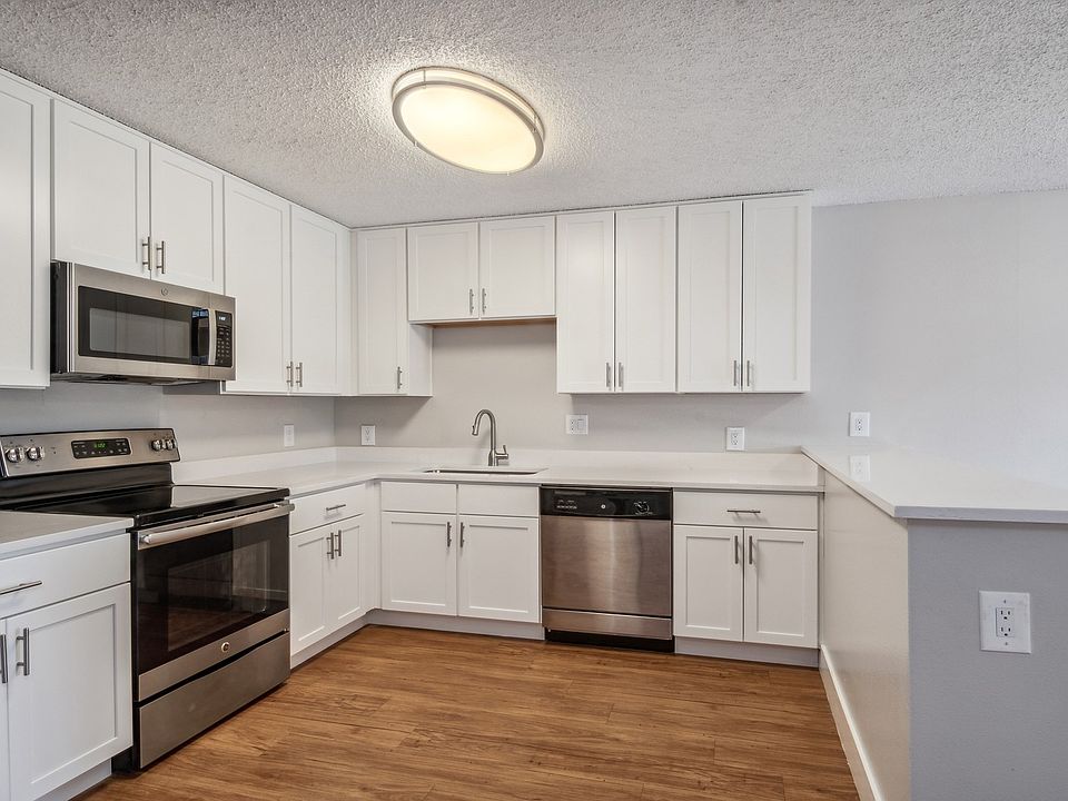Kitchens offer stainless steel appliances and wood flooring