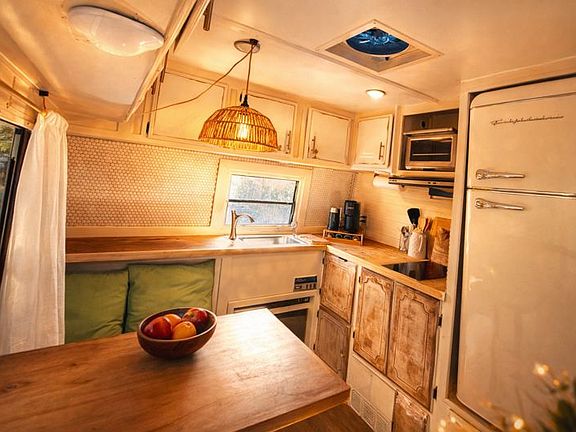 Kitchenette features electric cooktop, toaster oven, full fridge/freezer, and all cooking and serving ware.
