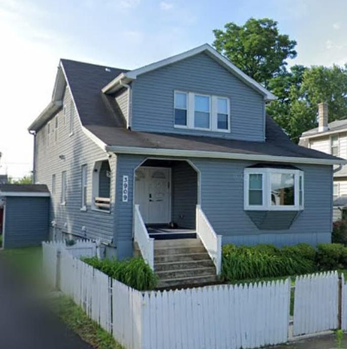 view from the front of the house (white fence is no longer there put the posts are so it can easily be replace with plastic or wood fencing)