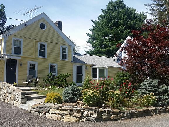 A's front entrance to living room on right by picture window. 2nd entrance to A thru regular garage door. Blue door is entrance to 1 bedroom unit