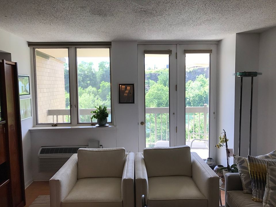Living Room with balcony facing cliff wall.