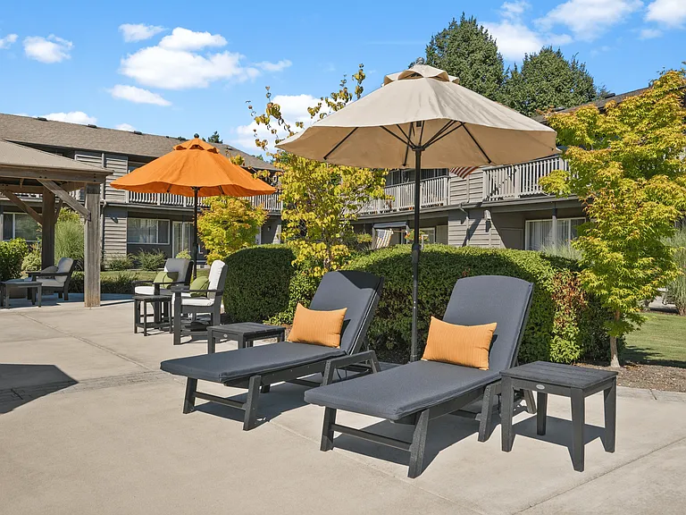 Relax in style at our community lounge with shaded seating and outdoor umbrellas.