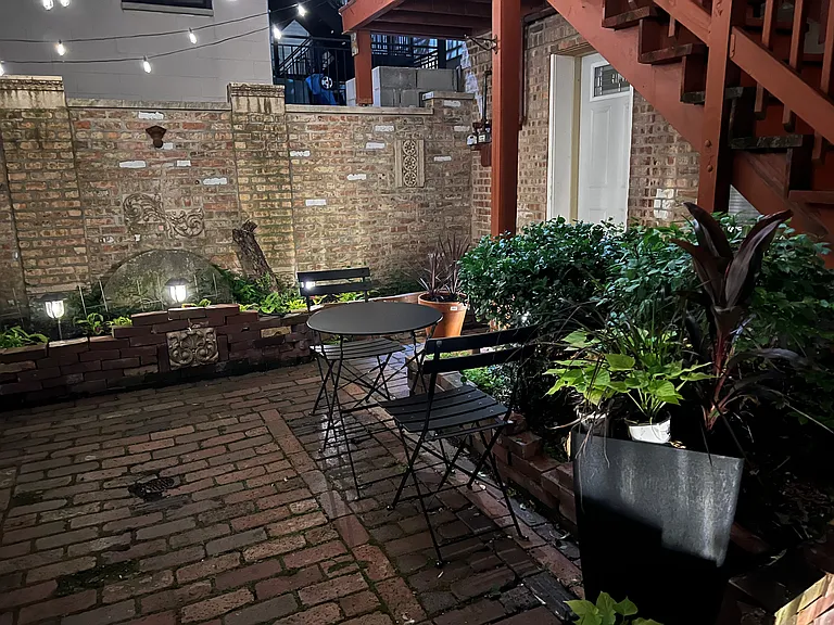 nighttime view of the courtyard where the coach house is - white door is the entry to the unit