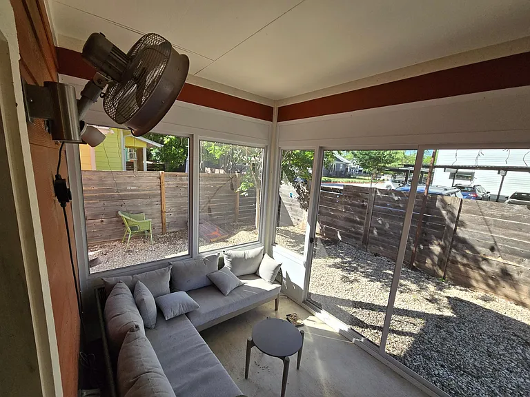 Enclosed back patio with high powered fan! Enjoy your days in the outside and be protected from the heat and mosquitoes with this screened in patio!