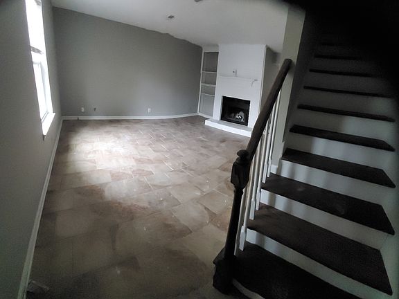 Bookshelves and wood burning fireplace in Living Room