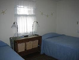 bedroom 1 with 2 twin beds and an en suite half bath