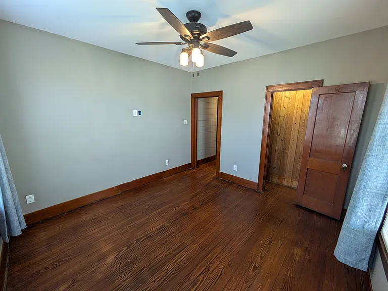 Bedroom 1 has ceiling fan, ample electrical outlets including for wall mount TV.