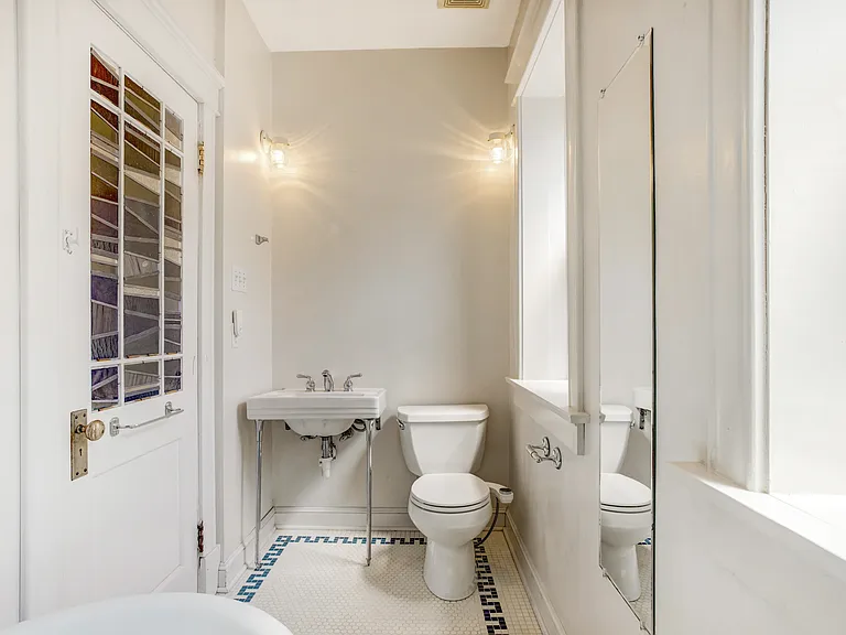 Bath with toilet and additional sink opposite of the clawfoot tub