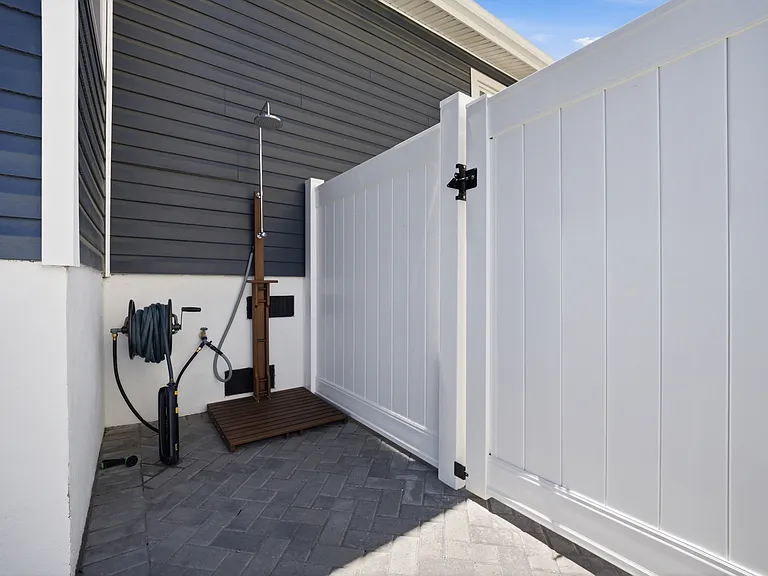 Beach-ready outdoor shower located just inside the main gate.