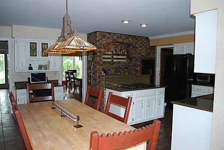 large kitchen open to family room, granite counters, built-in desk