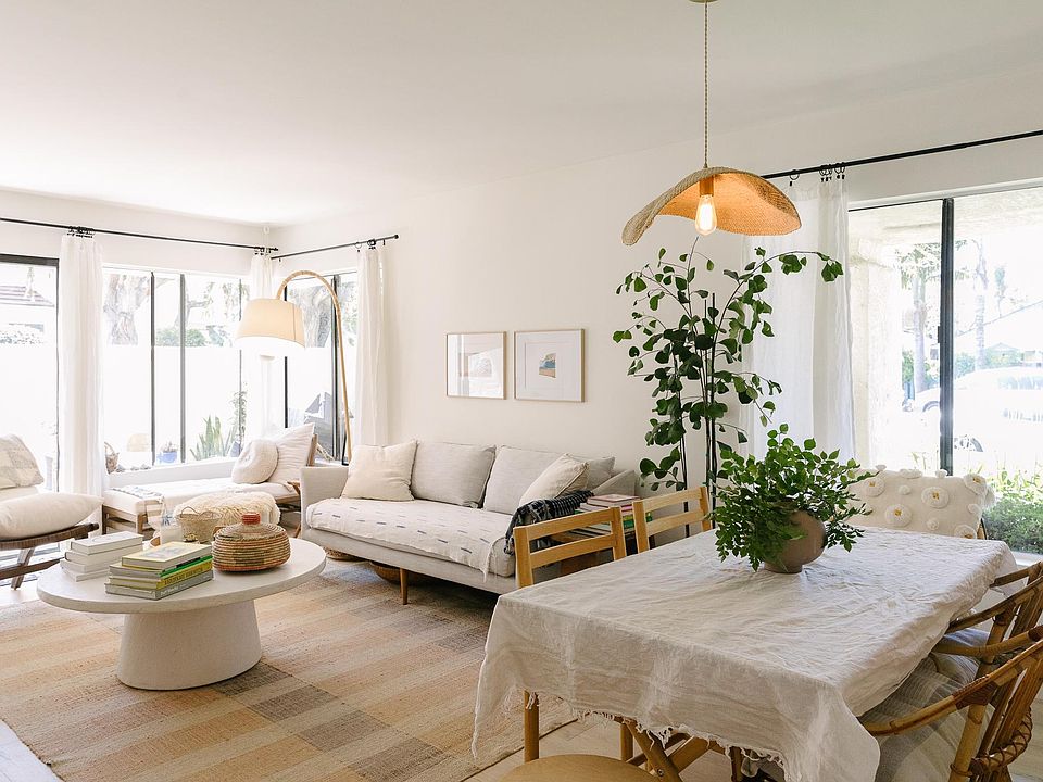 Mixed living and dining space with bright natural light, comfortable furnishings and cozy gas fireplace.