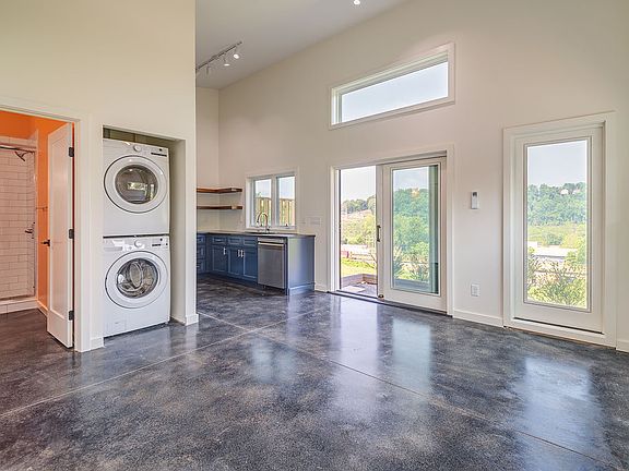 Spacious open concept studio with concrete floors and loads of light.