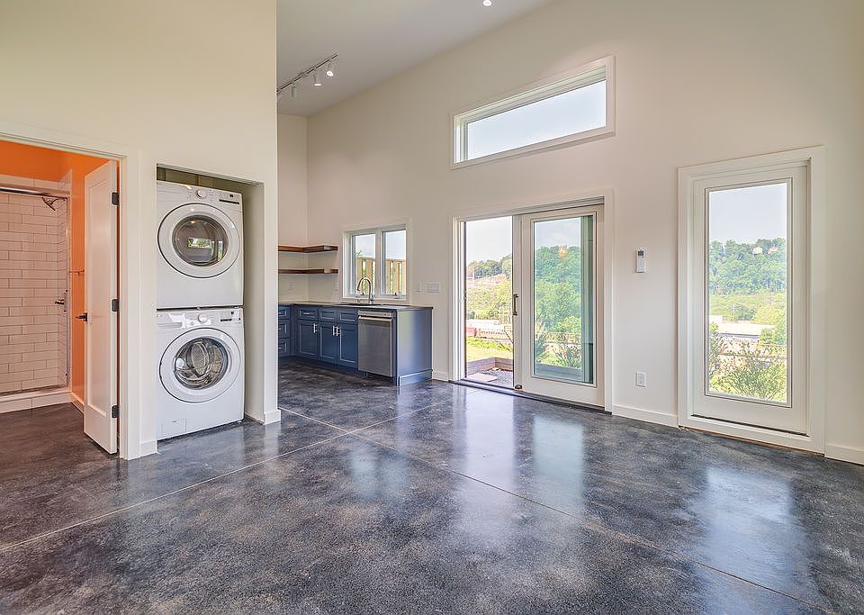 Spacious open concept studio with concrete floors and loads of light.