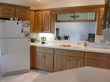 Nice updated oak kitchen cabinets includes pantry & bowed window
