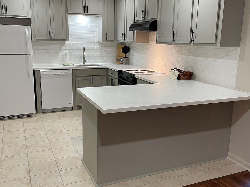 Renovated kitchen with new cabinets, quartz countertops, subway tile backsplash