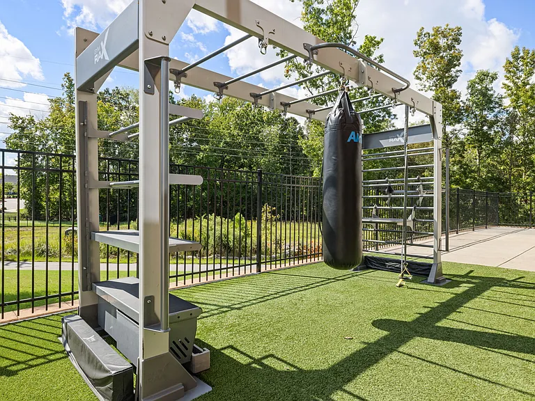 Functional Outdoor Workout Area with Boxing Bag and Training Rig
