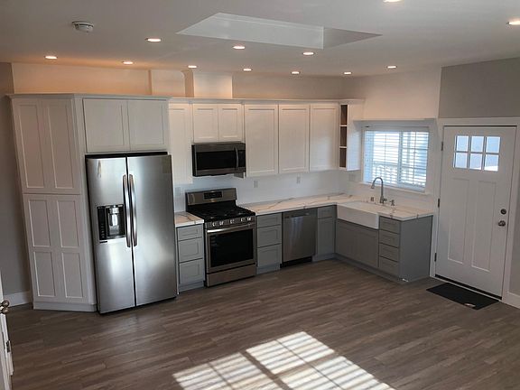 New Kitchen cabinets, countertops, stainless steel appliances, and beautiful sink.