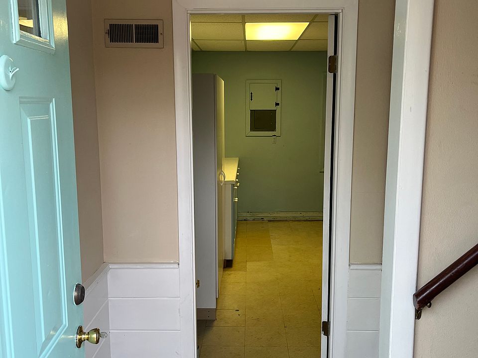 Foyer with entrance to laundry room on ground floor.