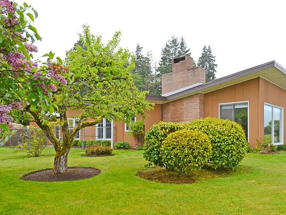 Another view of the home showing the well-maintained landscaping.