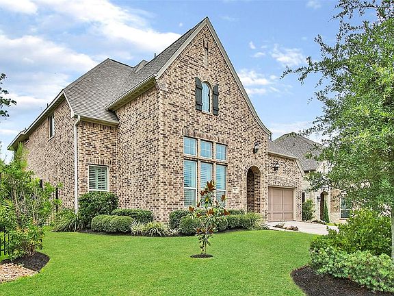 High & Dry during Hurricane Harvey, this home is well-elevated from the street for outstanding curb appeal. The tasteful brick exterior is classic and the wrought iron fence adds a nice custom touch.