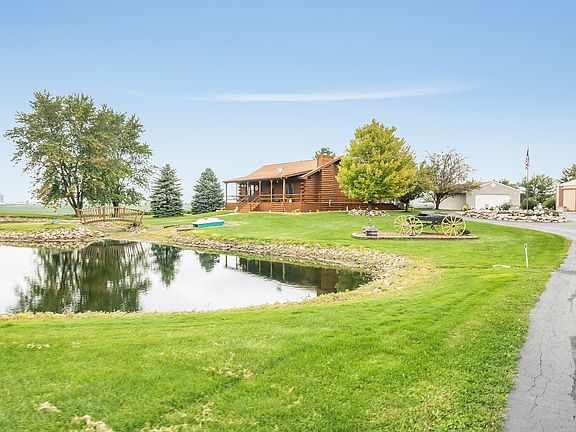 ~Driving into the property you will notice a serene pond ready for fishing or paddle boating.