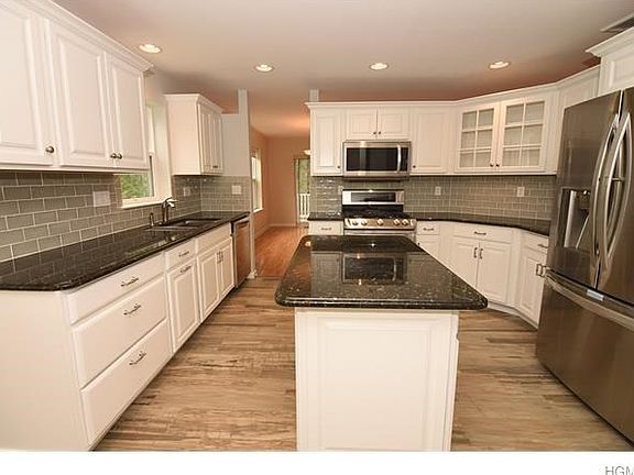 Renovated eat in kitchen-Timberlake Cabinets by LIS Customs Designs all maple wood. Backsplash is Spanish Billancourt Perla tiles from Terra Tile. Floor tile is Italian San Agostino Sanpea from Best Plumbing & Tile. Appliances are top of the line stainles