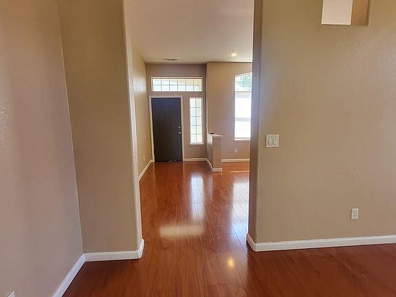 Hallway connecting living and family rooms - all wood floor
