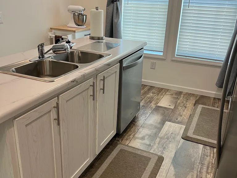 Kitchen island wih double sink, garbage disposal and dishwasher. Uility cart.