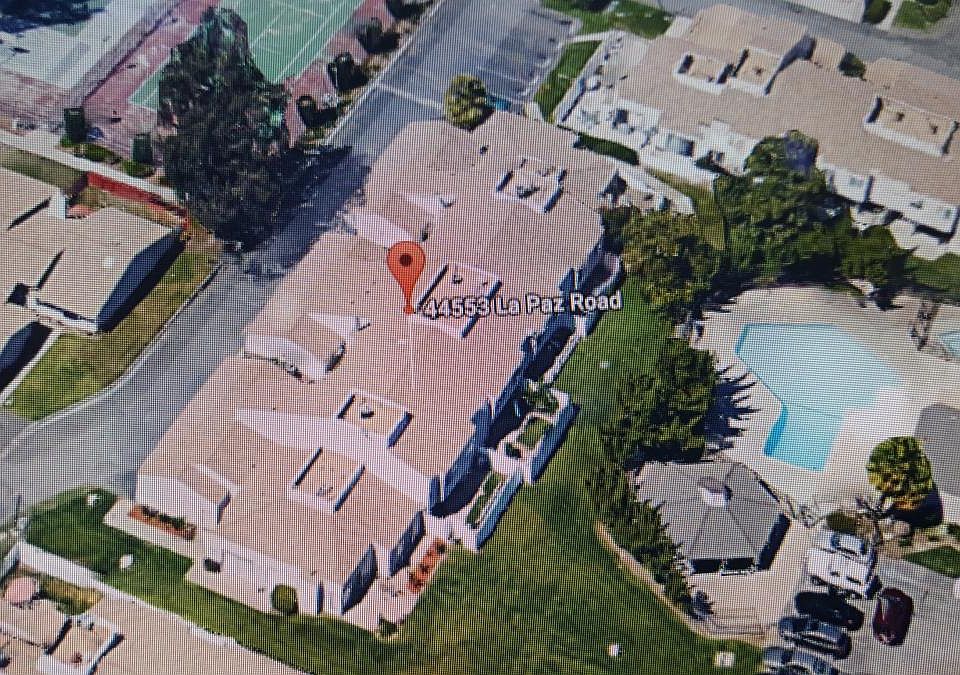 view from overhead shows our unit with the second fenced yard. There is a gate to the grassy area for kids to play. Pool is just across from the townhouse.