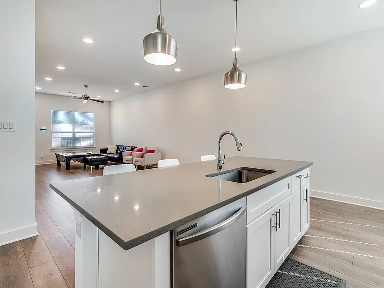Kitchen and island with sink and dishwasher.