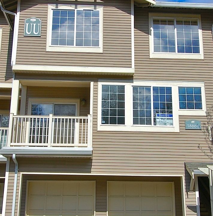 Exterior view of the townhouse. Note two-car garage, balcony