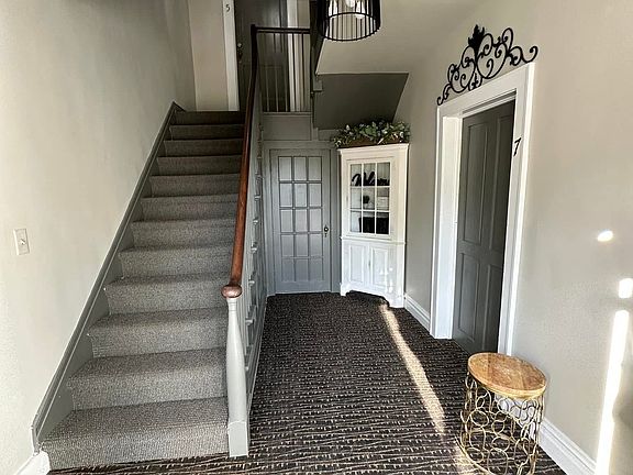 Unit is the door at the top of these stairs in the photo